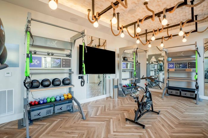 Fitness center with free weights, medicine balls, and a cycling bike