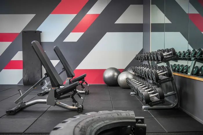Fitness center with tire flip and free weights at The Accolade luxury apartments for rent in Seattle.