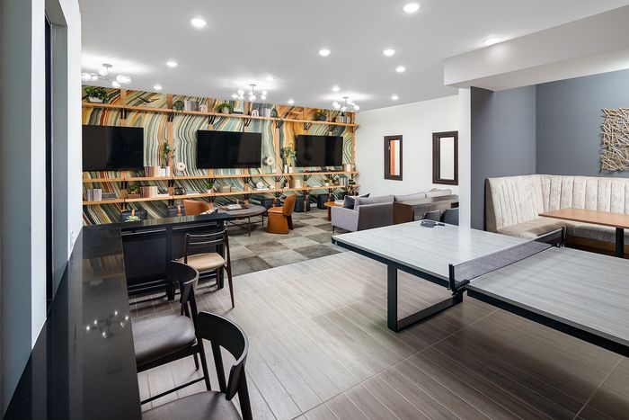 Resident lounge with TVs and a ping pong table at Union Knoxville apartments in Knoxville, TN.