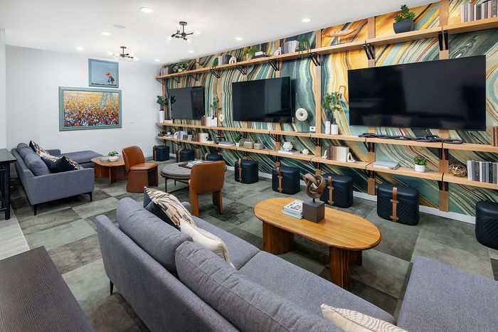Resident clubhouse with seating areas and TVs at Union Knoxville apartments near downtown Knoxville, TN.