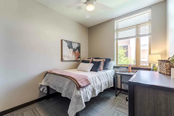 Bedroom with pink and navy pillows