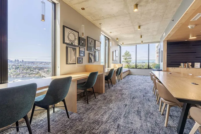 Resident study lounge with floor-to-ceiling windows at The Accolade apartments in Seattle, Washington.