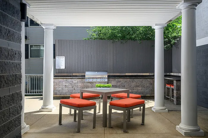 Charming outdoor patio with stylish seating and grill station, perfect for entertaining and relaxing moments.
