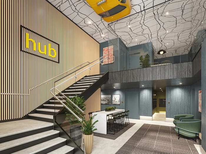 Modern lobby with stylish staircase and vibrant decor, featuring sleek wooden accents and a unique ceiling design.