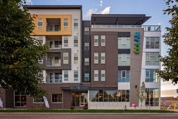 Modern apartment building with vibrant facade and spacious balconies, ideal for urban living in a prime location.