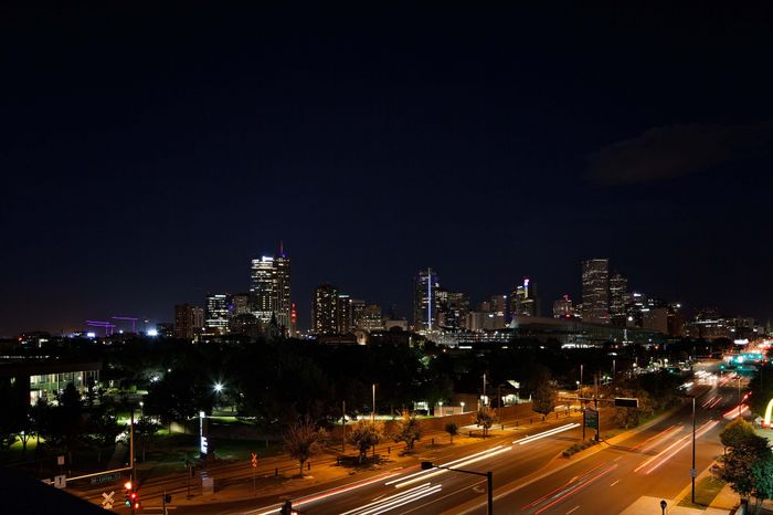 Vibrant city skyline at night showcasing bright lights and bustling energy.