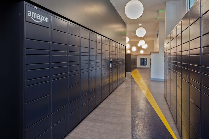 Sleek apartment hallway with modern Amazon lockers and elegant lighting, offering convenience and style in the building.