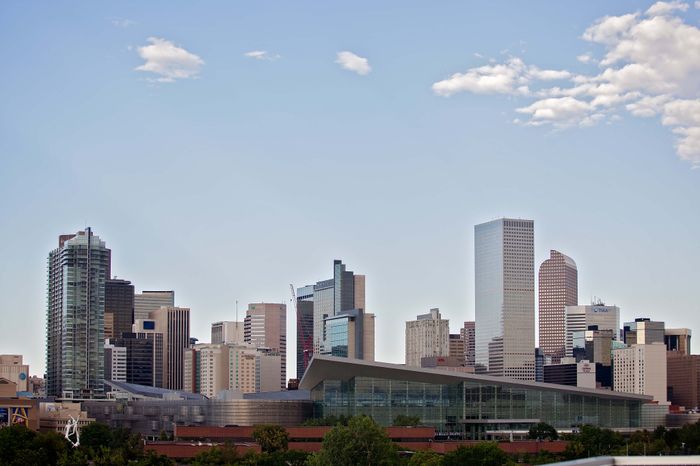 Vibrant cityscape showcasing modern skyscrapers against a clear blue sky, highlighting urban sophistication and architectural elegance.