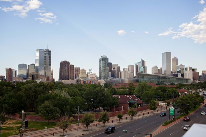 Vibrant cityscape featuring modern skyscrapers and lush greenery, offering urban convenience and natural beauty.