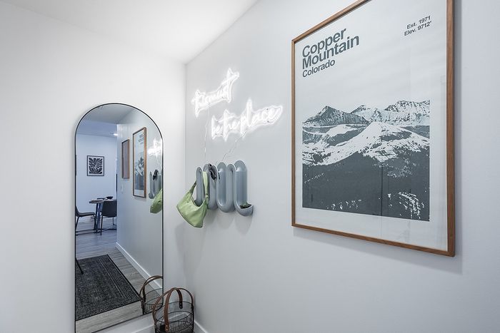 Chic hallway with a stylish arched mirror at our apartments in Boulder at Union 9Seventy.