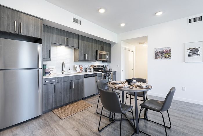 Contemporary kitchen with sleek grey cabinets in our apartments in Boulder at Union 9Seventy.