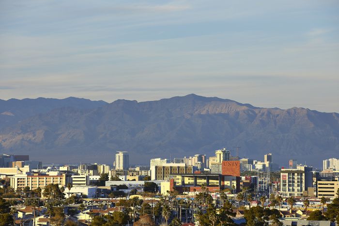 Breathtaking cityscape view with majestic mountains in the background, highlighting a blend of urban and natural beauty.
