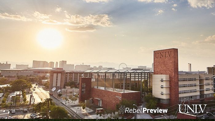 Breathtaking view of a vibrant campus and city skyline at sunset, with modern architecture and scenic atmosphere.
