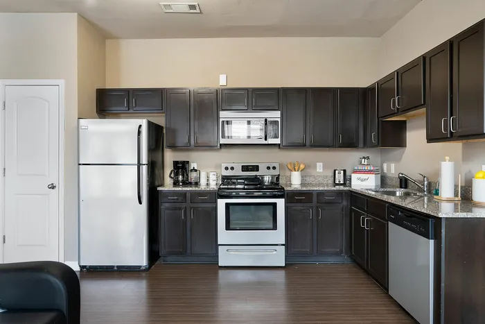Kitchen space in our Kennesaw State University Apartments with hardwood floors and stainless steel appliances at The Blake.