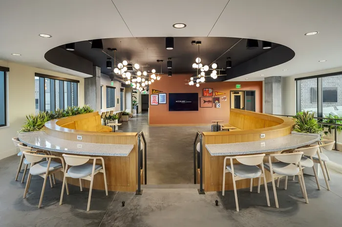 Elegant and modern office space with stylish lighting, cozy seating, and contemporary design elements.