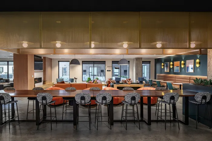 Chic and inviting shared lounge boasting modern decor, plush seating, and a warm, ambient atmosphere.