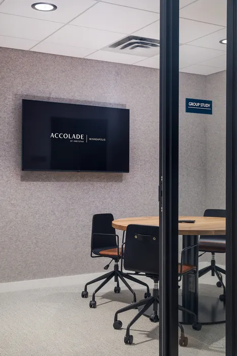 Modern group study room with cozy seating and a sleek wall-mounted TV, perfect for productive meetings in a stylish space.