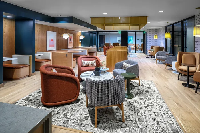 Chic and inviting lounge area featuring plush seating, modern decor, and ample natural light.