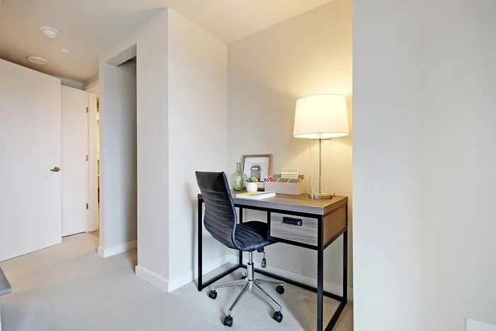 Chic and bright home office nook with a modern desk, sleek chair, and ambient lighting.