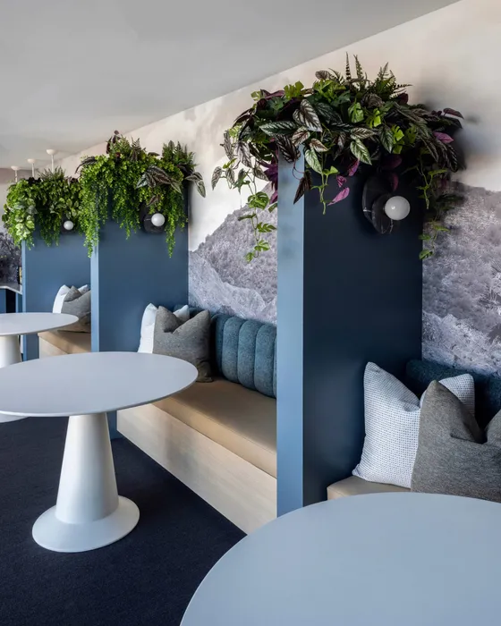 Chic and modern study nooks with stylish seating, lush greenery, and elegant round tables, creating a serene atmosphere.