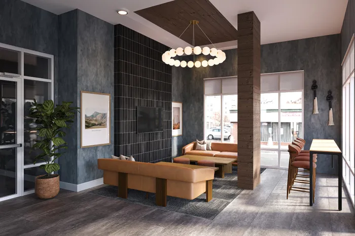 Modern lounge area with stylish leather seating, sleek d&eacute;cor, and large windows showcasing ample natural light.