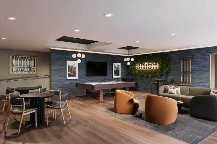 Chic apartment lounge with modern decor, cozy seating, and a pool table, perfect for entertaining and relaxation.