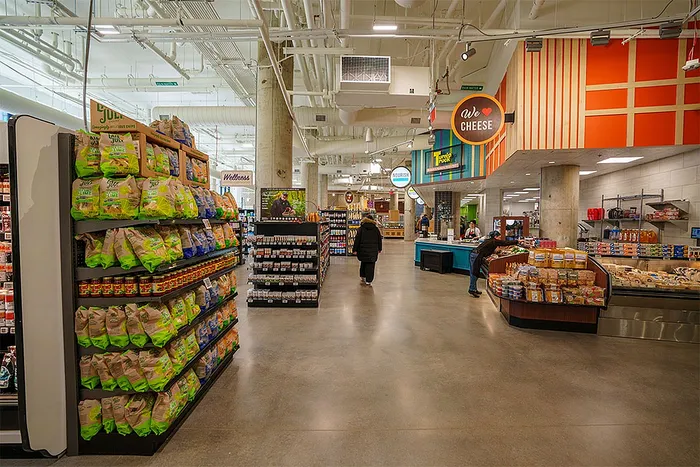 Bright and spacious grocery store interior with a variety of products and colorful displays.