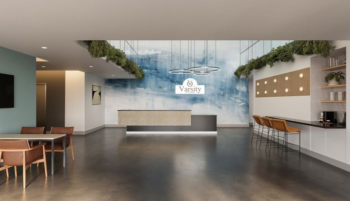 Modern apartment lobby with stylish decor, featuring trendy seating, elegant lighting fixtures, and a welcoming atmosphere at Varsity Ann Arbor.