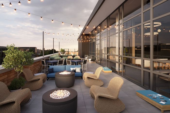 Luxurious rooftop patio with stylish wicker seating, cozy fire pits, and ambient string lighting for perfect evenings.