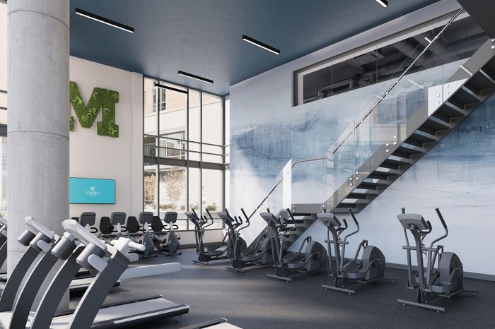 Modern fitness center with state-of-the-art equipment, sleek design, and natural light, perfect for an invigorating workout.