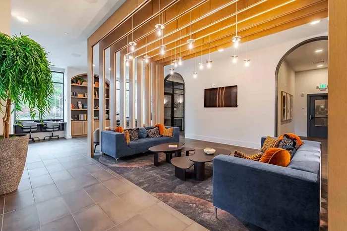 Elegant and modern lobby with plush seating, ambient lighting, and a cozy reading nook, perfect for relaxation and social gatherings.