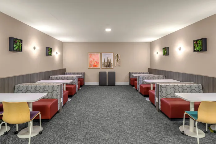 Elegant dining area with stylish booths, modern decor, and vibrant artwork, ideal for social gatherings or cozy meals.