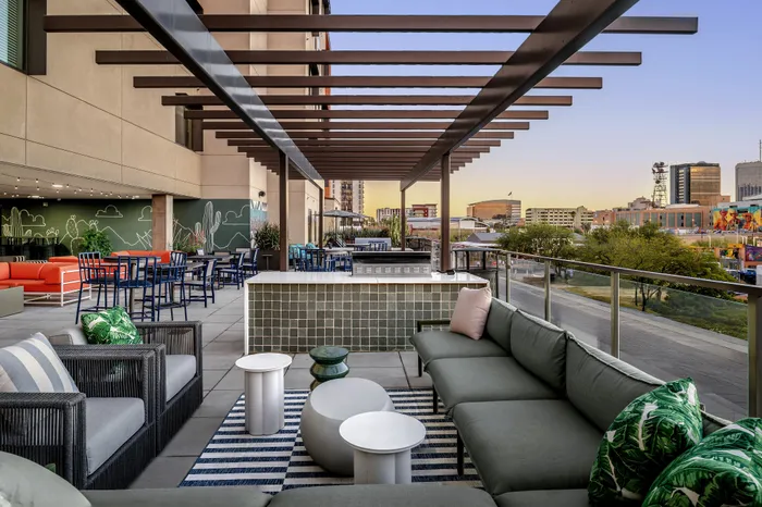 Modern rooftop terrace with stylish seating, vibrant decor, and stunning city views for a luxurious urban lifestyle.