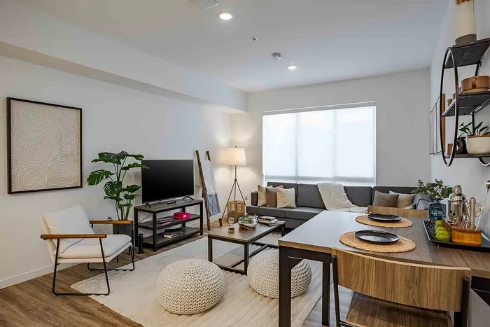 Inviting living room with modern decor, cozy seating, and abundant natural light, perfect for relaxation and entertaining.