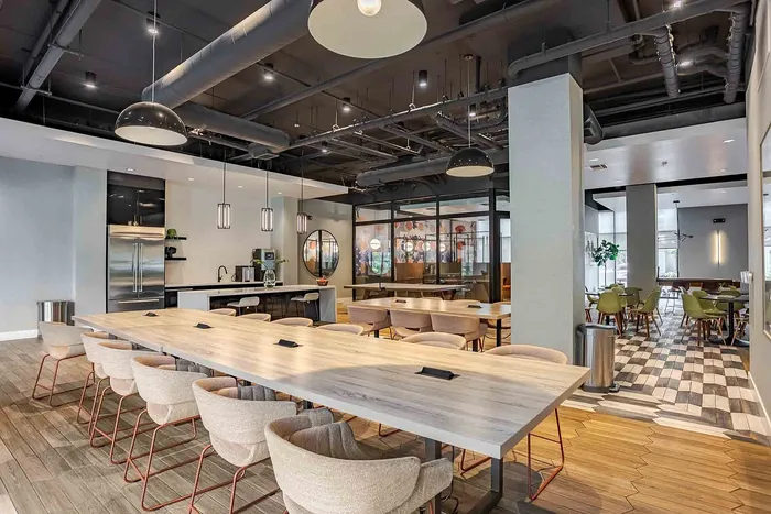 Contemporary open-plan dining area with modern pendant lighting and stylish wood flooring in a sophisticated apartment setting.