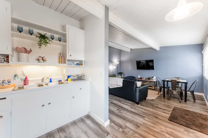 Bright and inviting open-plan living area with modern kitchen, cozy seating, and stylish dining space.