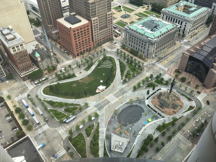 Breathtaking aerial view of a vibrant urban park surrounded by stunning architecture, showcasing a harmonious blend of greenery and cityscape.