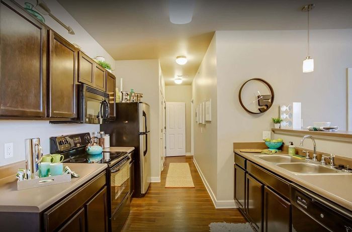 Elegant kitchen with sleek cabinetry, modern appliances, and warm wood flooring, perfect for culinary enthusiasts.