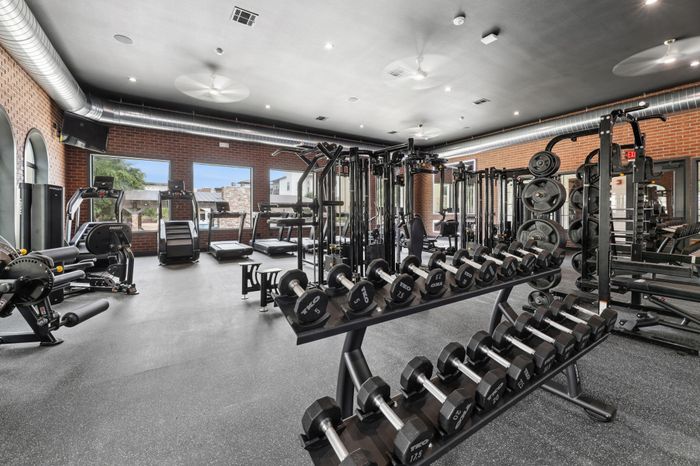Fitness center strength training equipment at Union San Marcos, furnished apartments in San Marcos, TX.