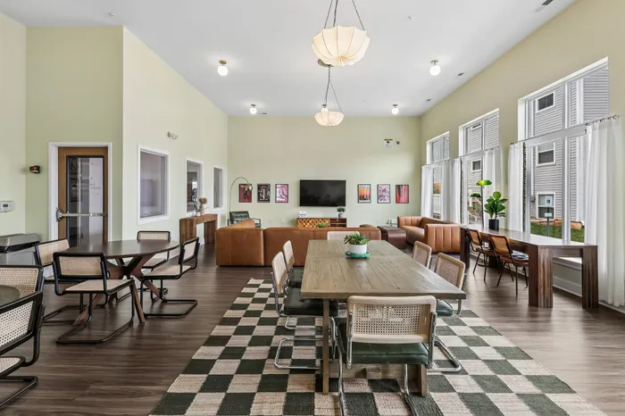 Inviting community lounge featuring modern seating, large windows with natural light, and stylish decor, perfect for social gatherings.