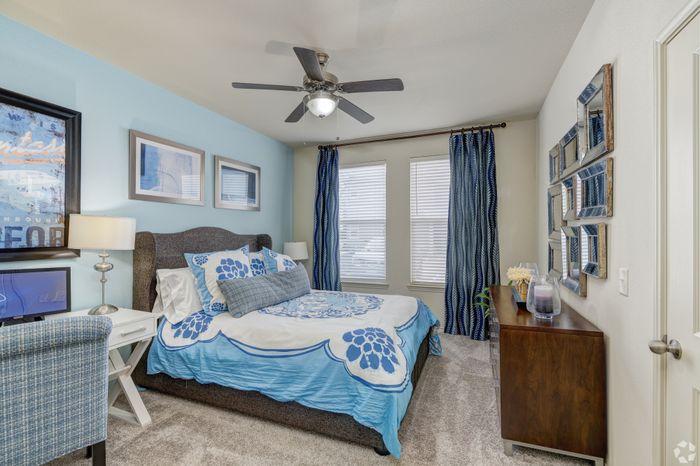 Charming bedroom featuring elegant blue accents, cozy bedding, and modern decor for a serene atmosphere.