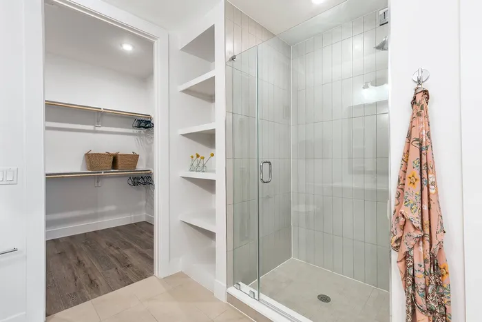 Walk-in frameless shower with floor-to-ceiling tile