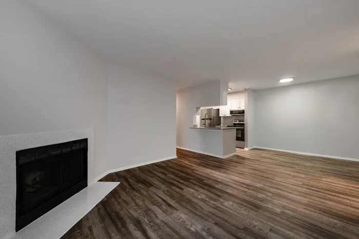 Renovated living room and fireplace with hardwood like floors