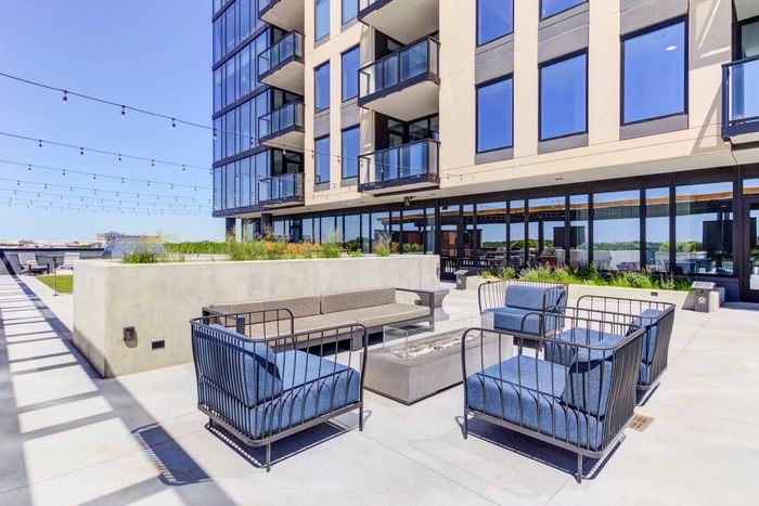 Outdoor lounge seating situated around an enclosed fire pit