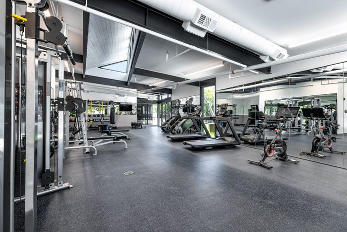 Fitness center with cardio and strength-training equipment at Perch Apartments.