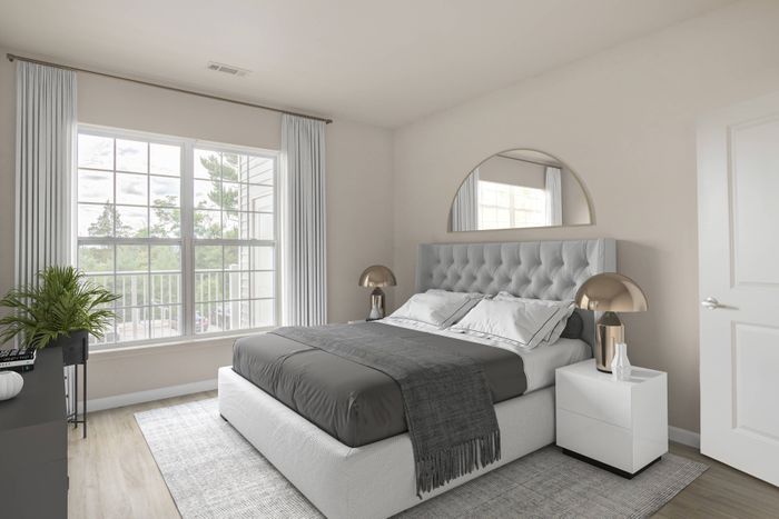 Bedroom looking out to balcony in an Ossining apartment for rent.