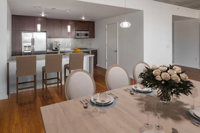 Model kitchen at our apartments in Portland, OR, featuring stainless steel appliances and wood laminate cupboards.