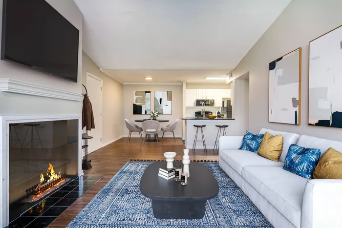 Open concept living area looking into dining and kitchen areas