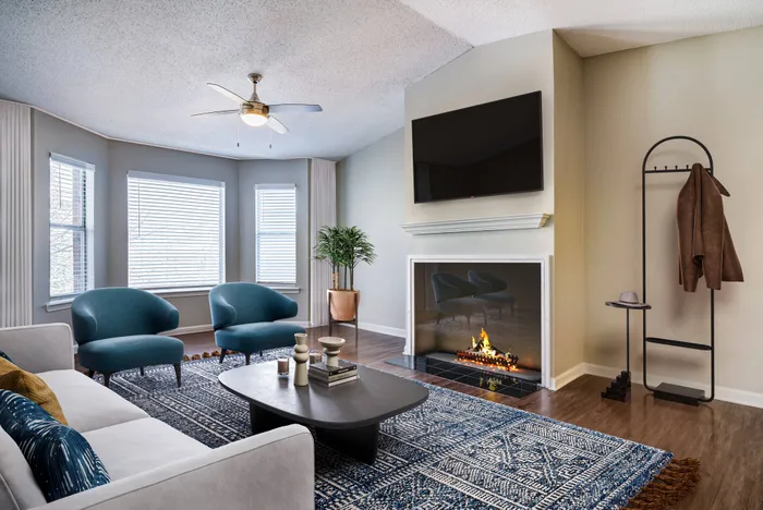 Living area's large windows and fireplace