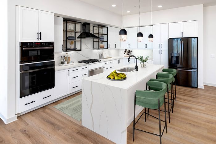 Luxe Penthouse Kitchen with Waterfall Quartz Counters and Upgraded Appliances